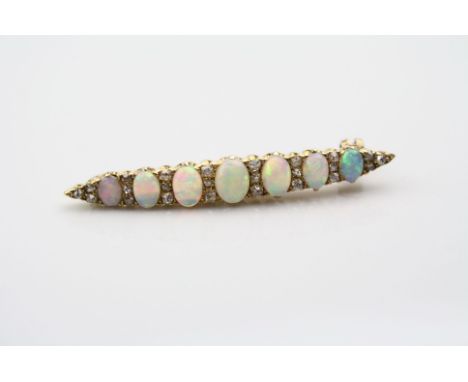 Opal and diamond yellow metal bar brooch, seven graduated precious white cabochon cut opals, displaying violet, blue, green, 