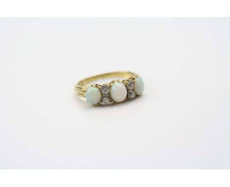 Victorian opal and diamond ring, three cabochon cut precious white opals displaying violet, green and orange play-of-colour, 