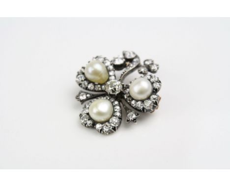 Victorian diamond and pearl brooch modelled as a clover leaf, the principle round old cut diamond weighing approximately 0.75
