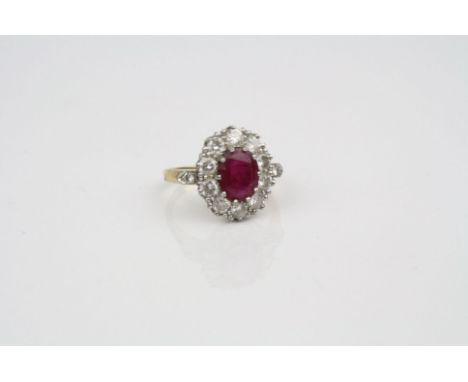 Lead glass filled ruby and diamond 18ct yellow gold white gold set cluster ring, the centre oval mixed cut ruby measuring app