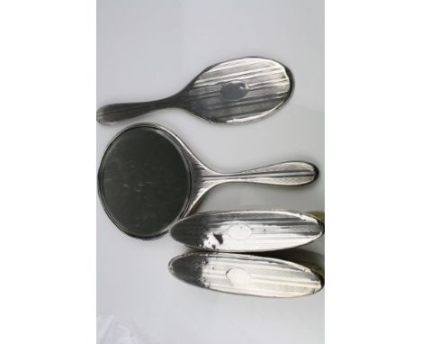 Early 20th century silver part dressing table brush set, comprising hand mirror, two clothes brushes and the silver back of t