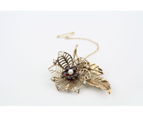 Garnet and pearl 9ct yellow gold flower head brooch, central pearl with five round mixed cut garnets central cluster, pierced
