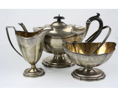 Edwardian silver three piece tea service comprising pedestal teapot, swing handled sugar bowl and milk jug, each raised on st