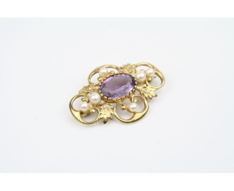 Amethyst and pearl 9ct yellow gold brooch, central oval mixed cut amethyst, six pearls to openwork scroll surround with textu