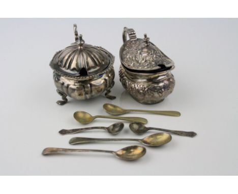 Silver mustard pot raised on three feet, shell shoulders, cast shell design border, hinged lid, baluster finial, blue glass l
