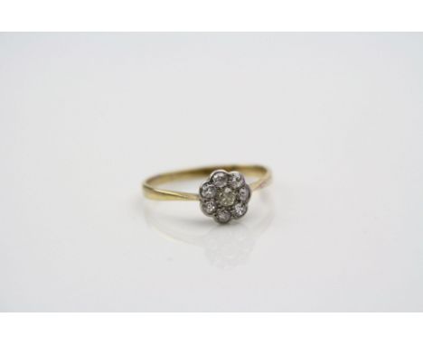 Yellow diamond 18ct yellow gold platinum set flower head cluster ring, the central round brilliant cut yellow diamond weighin