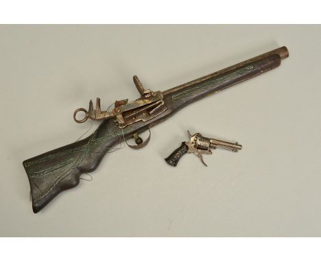 A SMALL 5MM PIN-FIRE REVOLVER, bearing no maker's name, it is overall machine engraved, including its grips, its action is cu