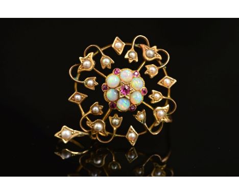 AN EDWARDIAN GOLD, OPAL, RUBY AND PEARL PENDANT, circular open work design, measuring approximately 28mm in diameter, stamped