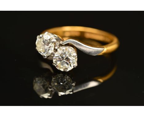 A TWO STONE CROSS OVER DIAMOND RING, two round brilliant cut diamonds, measuring approximately 5.2mm in diameter each, estima