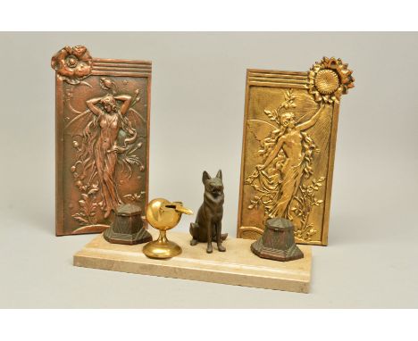 AN ART DECO DESK STAND, the cafe au lait colour marble mounted with a pair of bronzed spelter inkwells flanking a seated Alsa