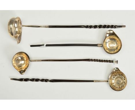 THREE 18TH CENTURY WHITE METAL COIN SET TODDY LADLES, all on twisted whale bone handles, two with Queen Anne coins dated 1710