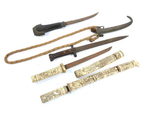 Two 19th Century Japanese Aikuchi, each with single edge steel blade and sectional bone grip and saya carved with figures and
