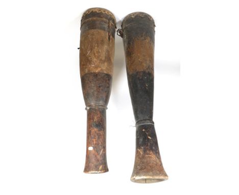 Two Early 20th Century Zulu Tall Drums,  each carved from a single softwood trunk, the hide skin stretched and secured by dow