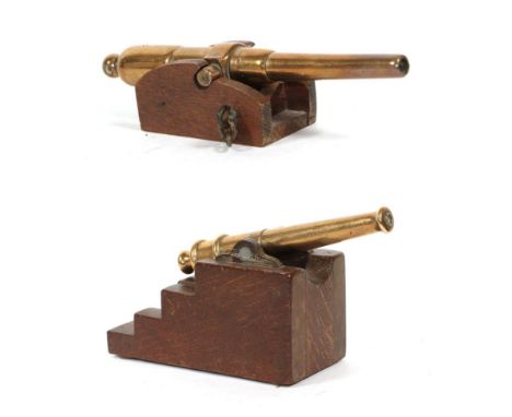 Two Small Victorian Bronze Desk Cannons, with 14cm and 14.5cm barrels, globular cascabels and cylindrical trunnions, on oak b