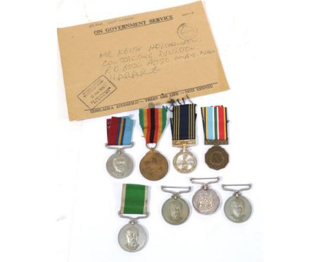 A Collection of Eight Rhodesian Medals: - Police Reserve Medal to A5918 A/F/R Chiwungwej; For Service Medal to 8718 Cpl B Maf