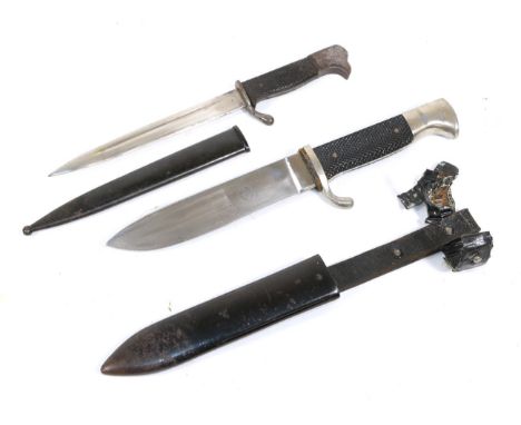 A German Hitler Youth Knife, the 14cm single edge steel blade stamped with RZM mark over M7/62, the plated white metal hilt w