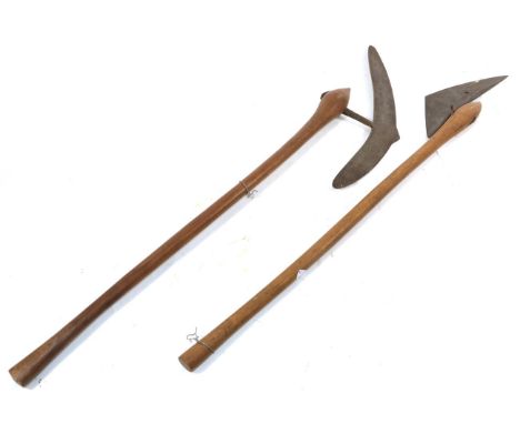 A 20th Century Zulu War Axe, the 39cm crescent shape blade with cylindrical tang inserted into the ovoid head of the light ho