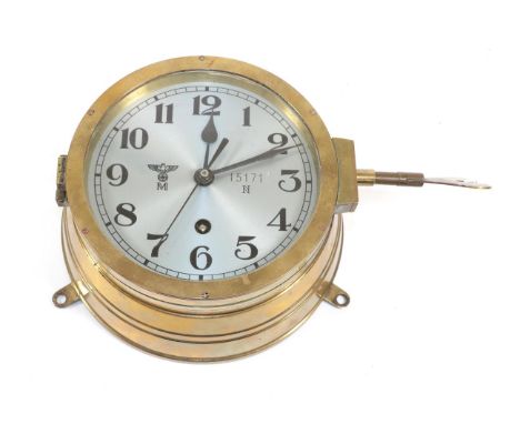 A German Third Reich Kriegsmarine Bulk Head Clock, in a brass drum case, the 14.5cm circular silvered dial with black Arabic 