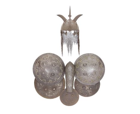 A Persian Steel Kulah Khud, A Bazu Band, And Five Indian Dhals All 19th Century The first Qajar and with domed skull etched o