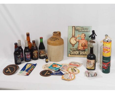 A collection of vintage international and commemorative Breweriana including: beer, bottles and cans, 20th century beer mats 