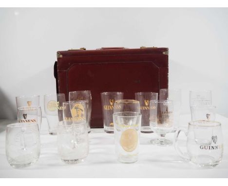 A group of 16 Guinness drinking glasses of various measurements including pints, half pints etc and a vintage pilots case. 