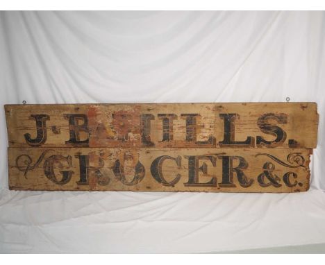 A vintage wooden shop sign reading 'J. B. Hills Grocer & Co' (2) approx 153cm x 22cm