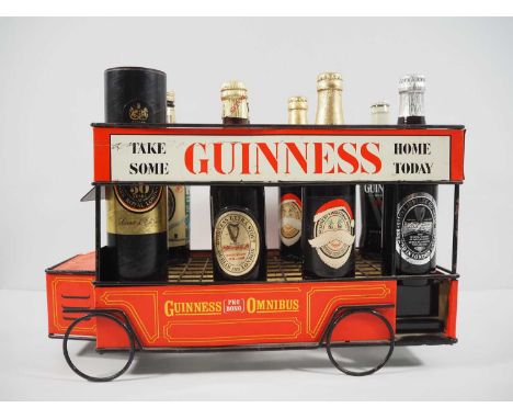 GUINNESS metal Omnibus beer cart bottle display by Acme Showcard Co Ltd (1965) with 8 mixed vintage bottles of GUINNESS to in