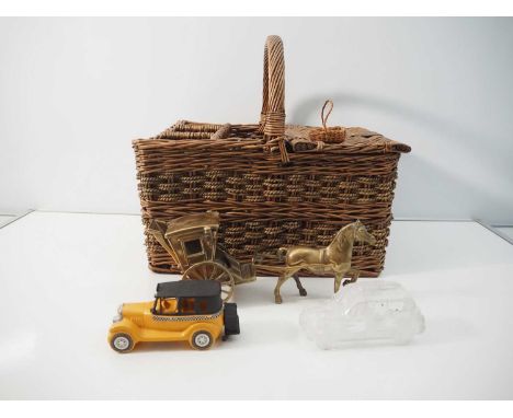 A vintage wicker picnic basket including leather and brass locking mechanism together with a brass Hackney carriage, a glass 