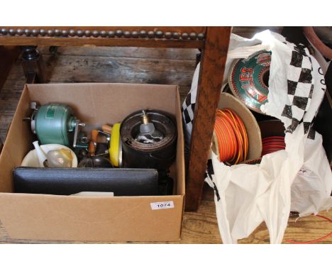 An assortment of mixed tools including cased measuring instruments and reels of wiring