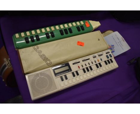 A Casio VL-Tobe, electric melodeon style instrument (VL-1) and a traditional Hohner Melodeon