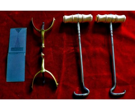 A Vintage pair of Victorian boot hooks dating from around the mid to late 1900's with a pair of Dunnett Spurs made from brass