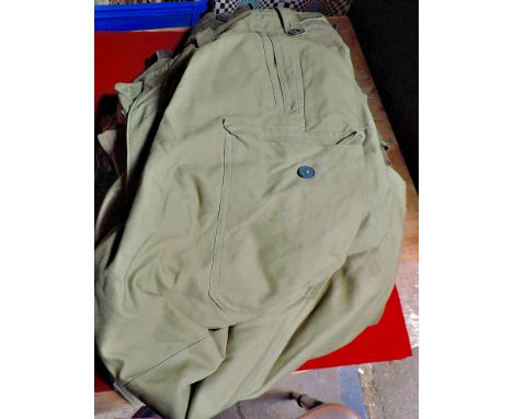 A mixed lot of vintage British military uniform accessories including, belts, shorts, shirts etc. Good lot.