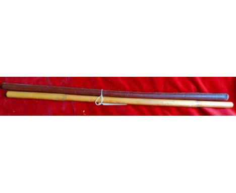 A pair of vintage officers swagger sticks. One in bamboo and the other is bound in brown leather with some slight separation 
