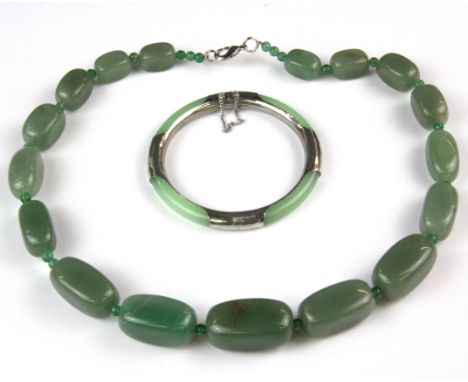 A Chinese white metal mounted hinged jade bangle and a hardstone necklace.