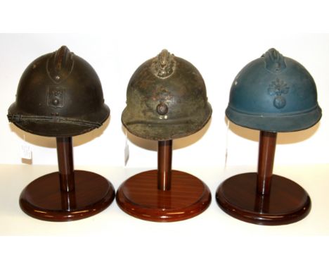 A World War II French Civil defense helmet, with two further French helmets.