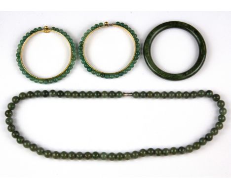 An olive green jade bead necklace with matching bangle and two jade bead gilt bangles.