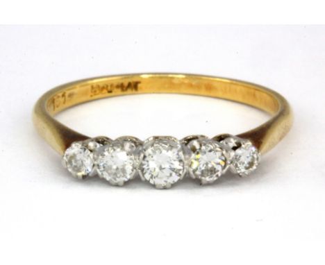 An 18ct yellow gold and platinum five graduated diamond set ring, (Q.5).