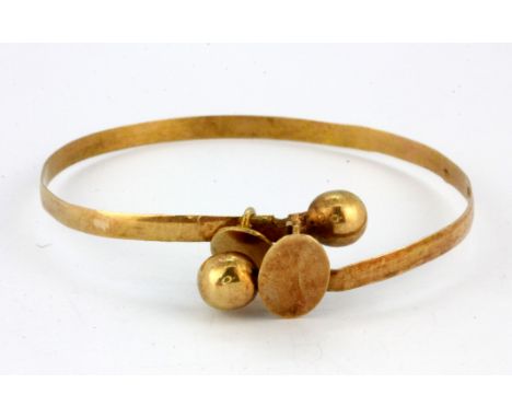 A yellow metal (tested minimum 9ct gold) bangle.