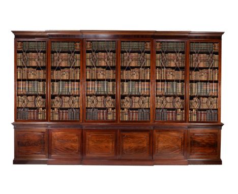 A George III mahogany library bookcase, circa 1790, of double breakfront outline, the stepped and Greek key moulded cornice a