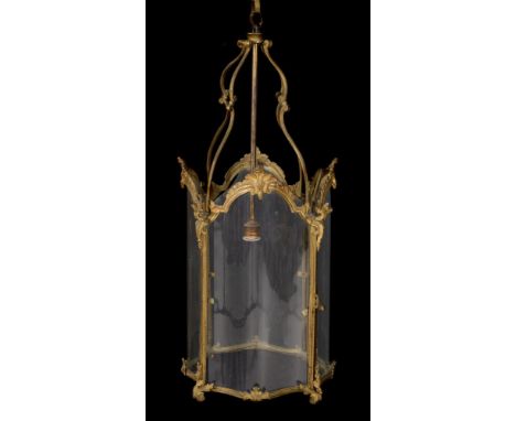 A gilt metal and glazed hall lantern in George III style, circa 1900, of serpentine outline, double scrolled ceiling supports