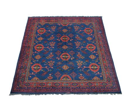 An Ushak carpet, the rich blue field decorated with stylised flowerhead and foliate motifs, within multiple borders and guard