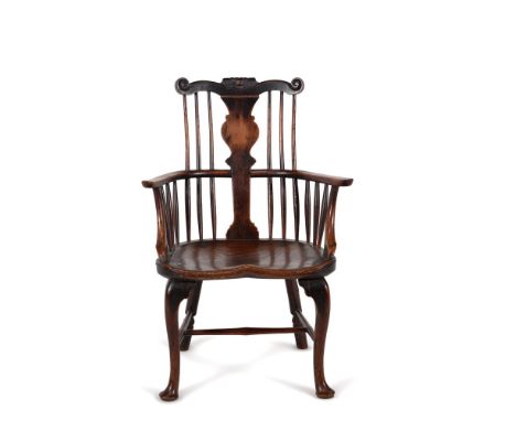 A George II elm and yew 'comb' back Windsor armchair, mid-18th century, from the Thames Valley region, the scroll carved cent