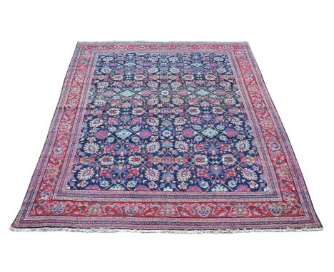 A Ziegler Mahal carpet, the dark blue field decorated with an overall design of flowerheads and colourful foliage, within a m