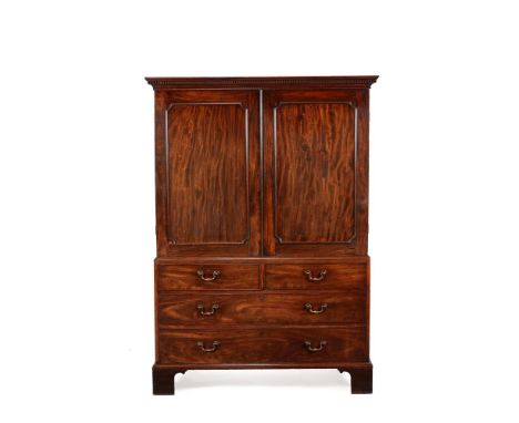 A George III mahogany clothes press, circa 1770, in the manner of Thomas Chippendale, the dentil cornice above a pair of pane