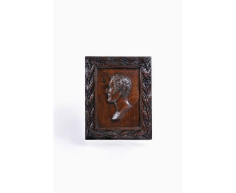 A stained hardwood, probably elm, commemorative portrait relief panel of Field Marshal Sir Arthur Wellesley, 1st Duke of Well