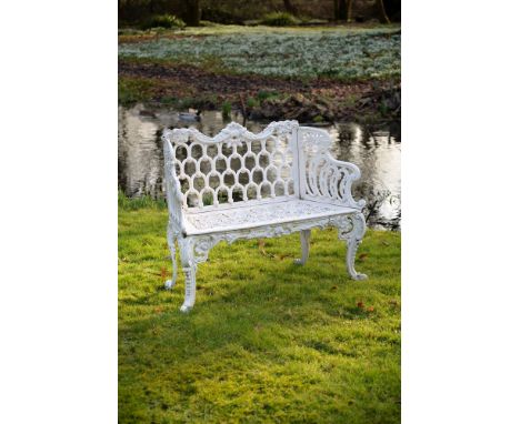 A white painted cast iron 'rose garden pattern' garden seat to a model by Carron &amp; Co, 20th century, the serpentine backr