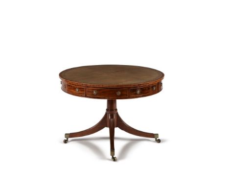 A George III mahogany drum library table, circa 1800, the circular top with tooled leather inset surface, above four frieze d
