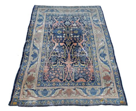 †A Bidjar carpet, of Garrus design, the blue field decorated throughout with stylised foliate branches and flowers in an asym