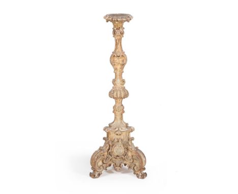 A William &amp; Mary carved gilt wood and gesso altar stick or torchere, circa 1690, the circular top above an elaborately ca