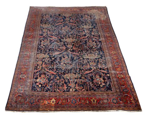 A Bidjar carpet, of Garrus design, the dark blue field decorated with an asymmetric design incorporating stylised foliate bra